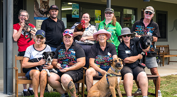 The RSPCA Mackay Shelter team pose for a photo with dogs, cats and roosters